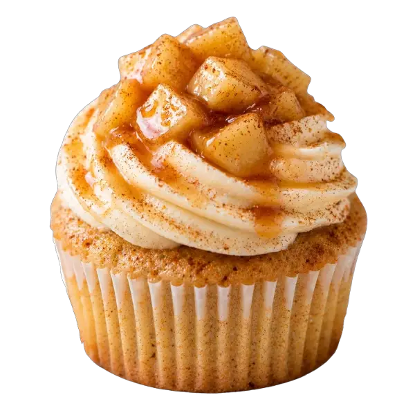 A cupcake topped with swirls of frosting and diced apple pieces, coated in rich caramel sauce and a sprinkle of cinnamon.