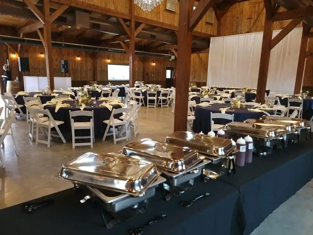 Colorado Q buffet arranged for a catered celebration in a warm wood venue